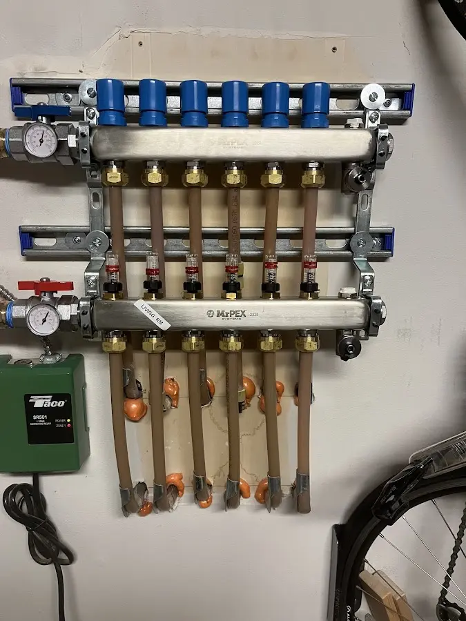 Plumber performing Water Heater Repair at a residential property in Dracut